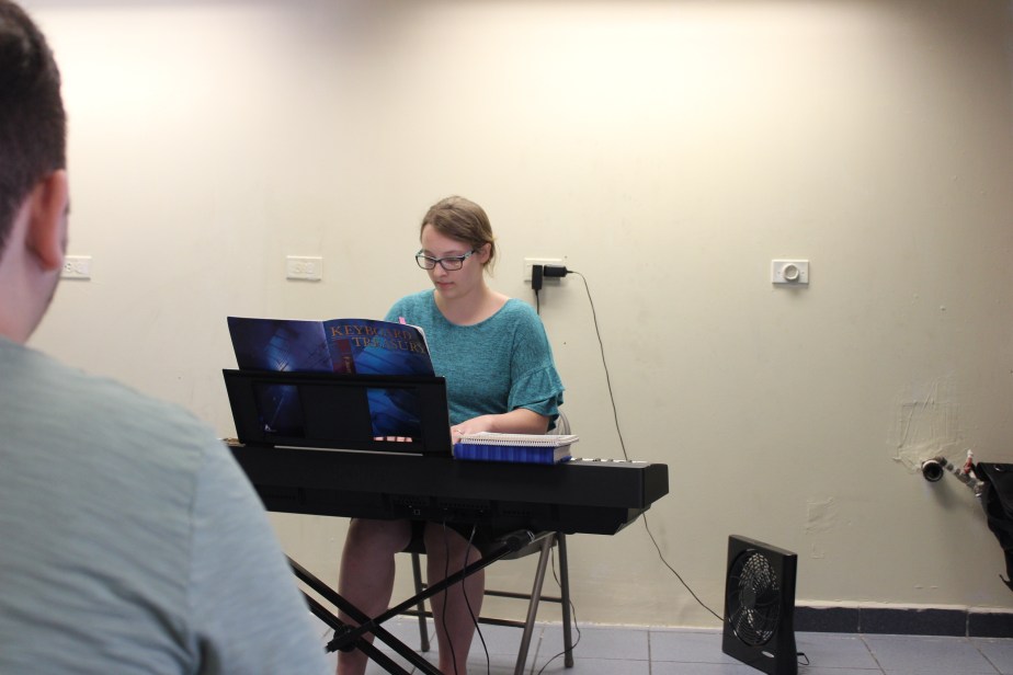 Young lady playing solo on keyboard